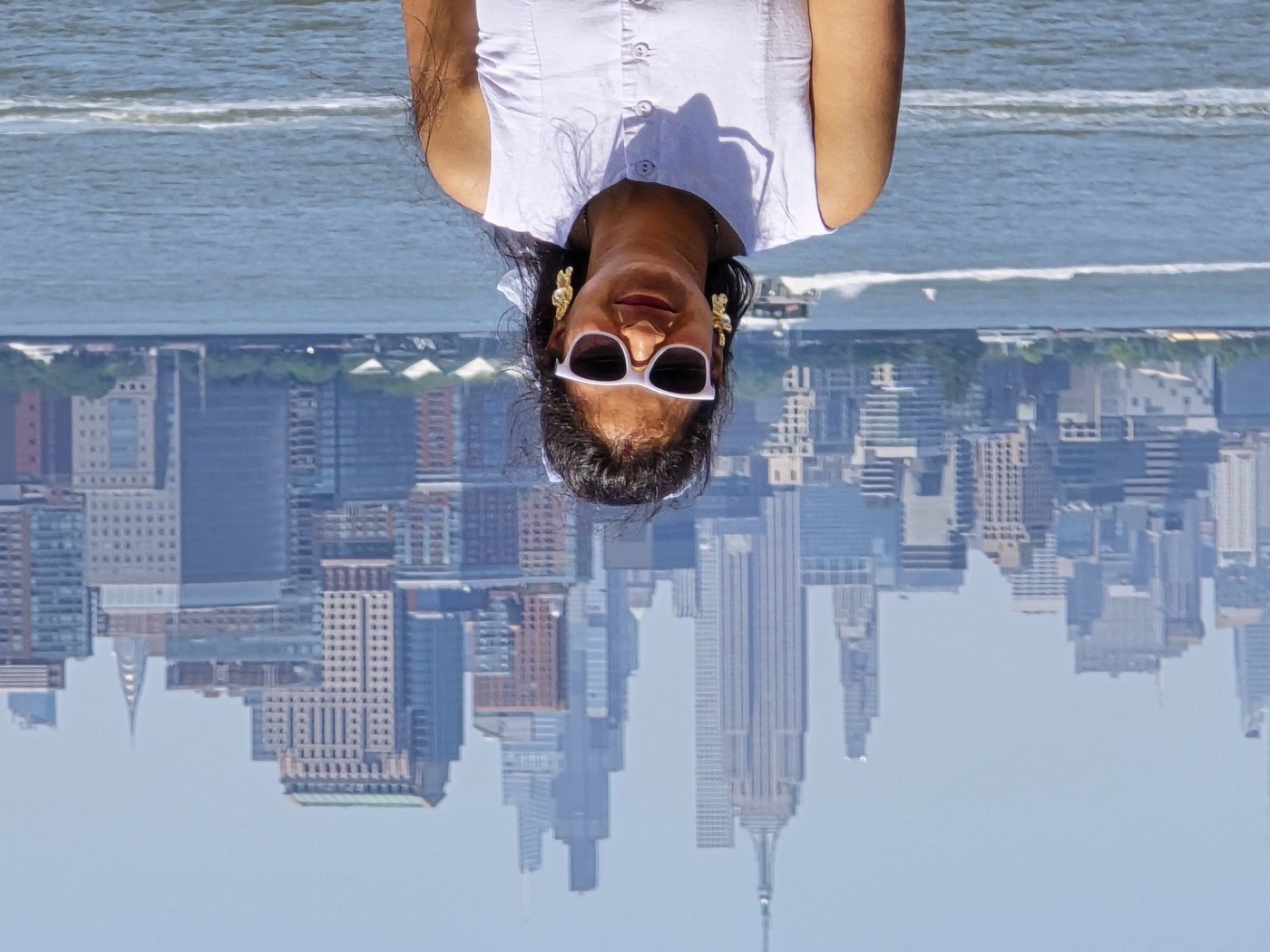Chandani with the Manhattan skyline across the water behind her